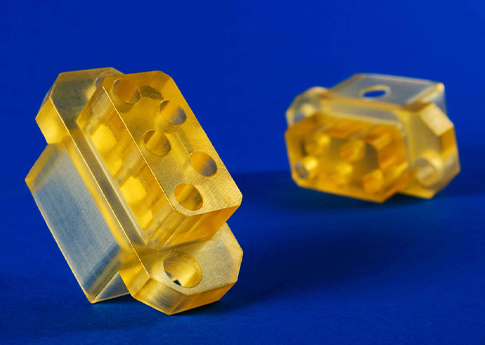 CNC Milled Polysulfone Insulator sockets for a cable assembly that go aboard a submarine. Polysulfone is high temperature material that is resistant to degradation at hot water temperatures as well as steam.